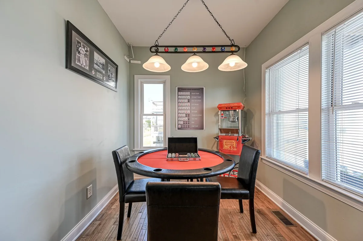 A cozy interior featuring a poker table, soft lighting, and a popcorn machine, evoking a fun, social atmosphere perfect for family game nights. The decor suggests a dedicated game space for relaxing after outdoor activities.